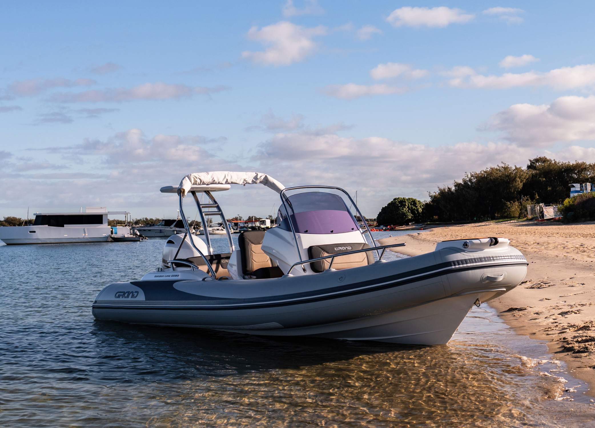 Grand G580 rigid inflatable boat beached on sand