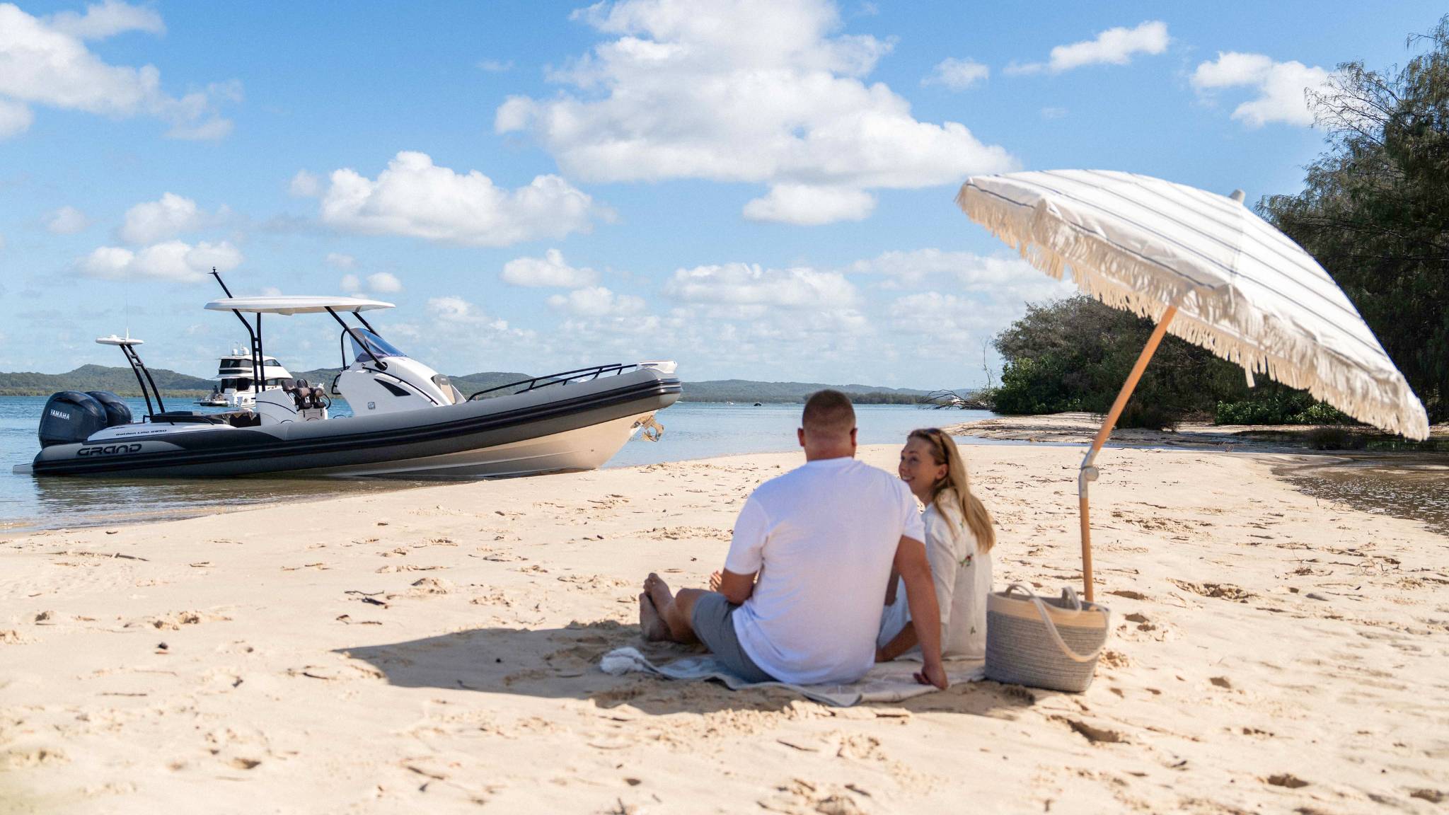 Grand G850 rigid inflatable boat beached on the sand