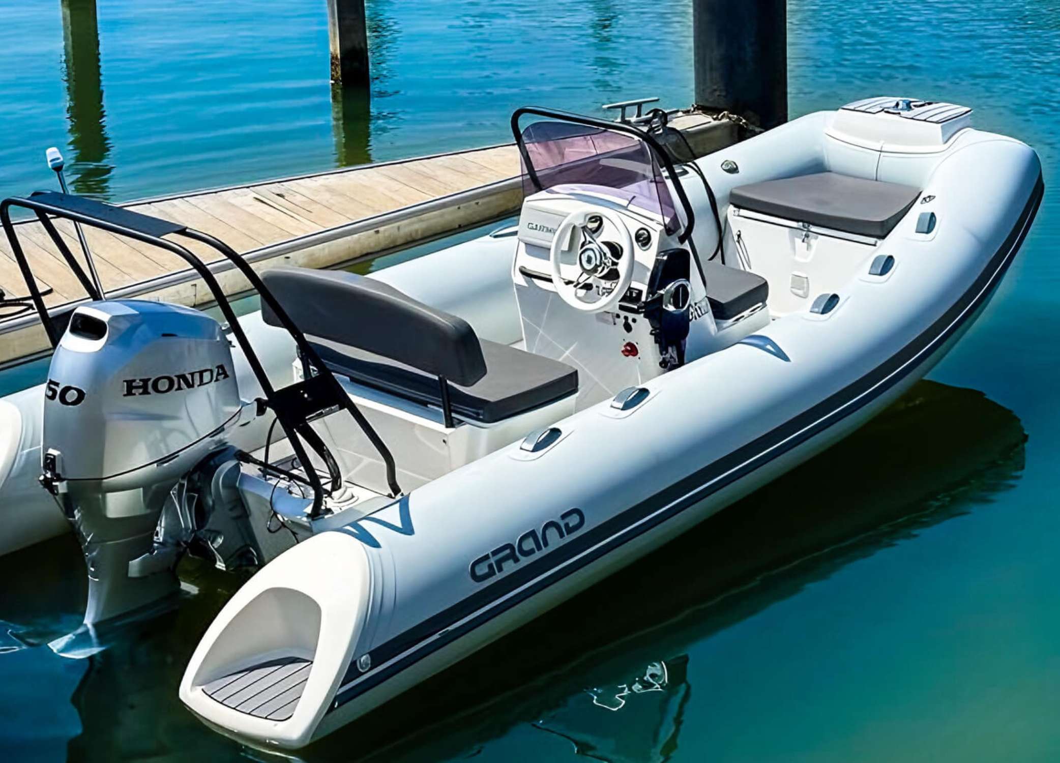 The Grand S470 tender boat moored next to a pontoon