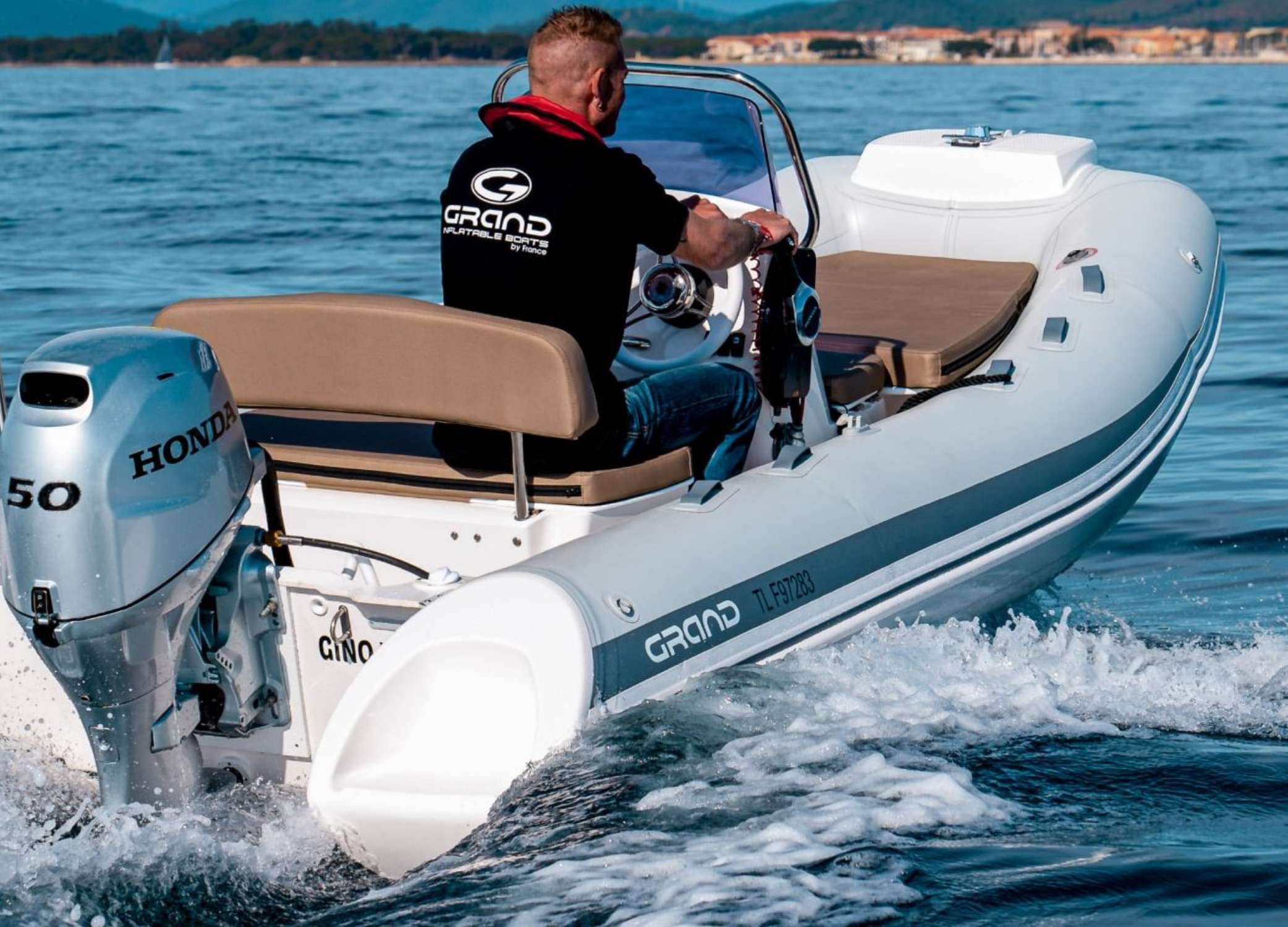 Man driving a 4.7 metre tender boat the Grand S470
