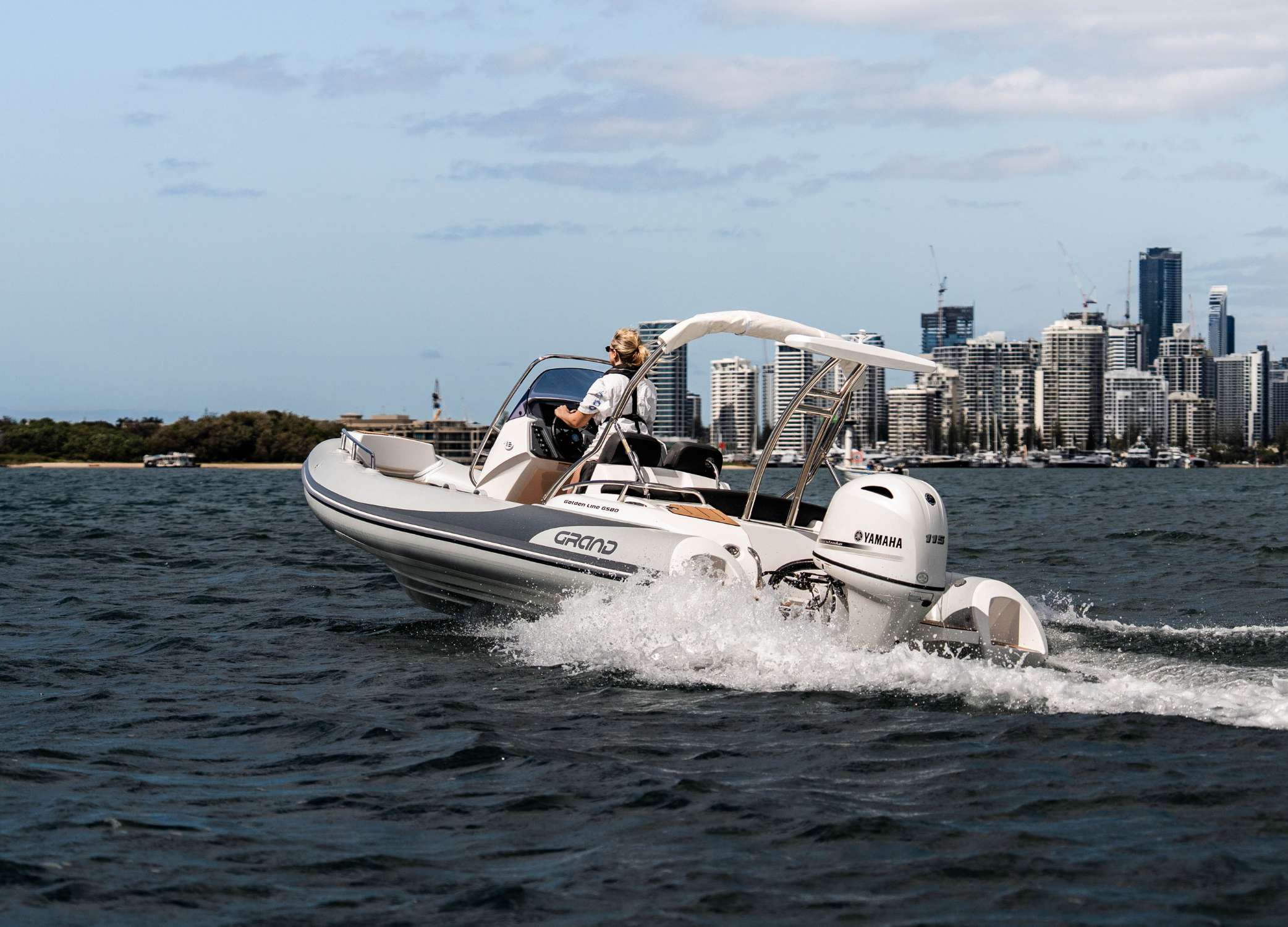 Woman driving a 5.8 metre rigid inflatable boat in the Gold Coast