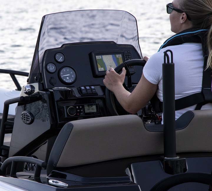 An up-close shot of the Grand G420 with a female passenger behind the driving console