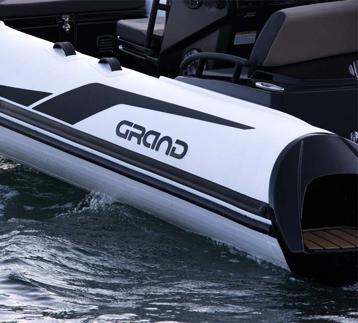 White tubes, black detailing and seadeck flooring in this up close shot of the Grand G420 yacht tender