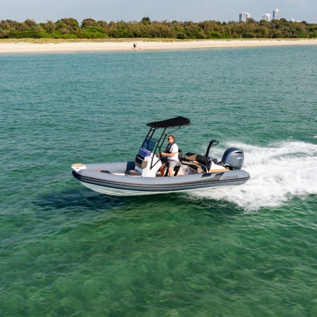 A grey Grand D600 rigid inflatable boat travelling on the water