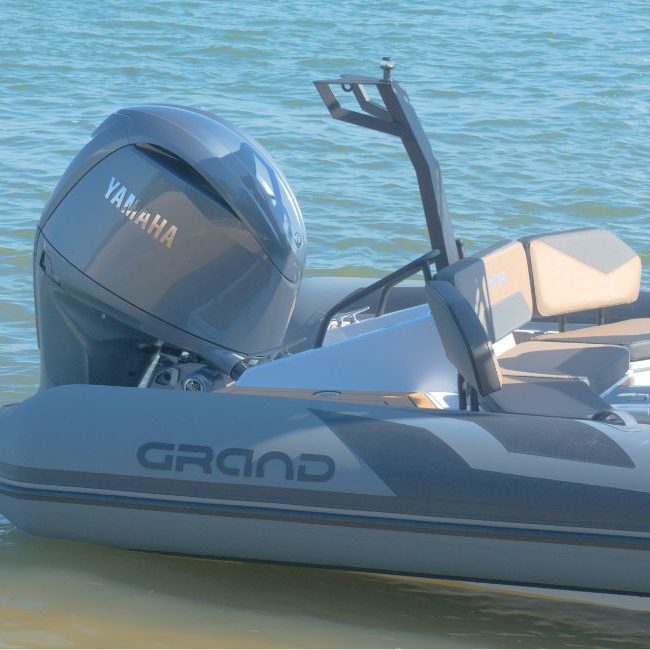 The stern of the Grand D600 for sale, with dark grey hypalon tubes and Yamaha 150HP outboard