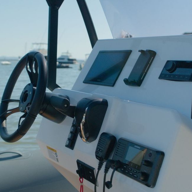 The dashboard on the Grand D600 with Garmin screens, phone charger, and Fusion speaker system