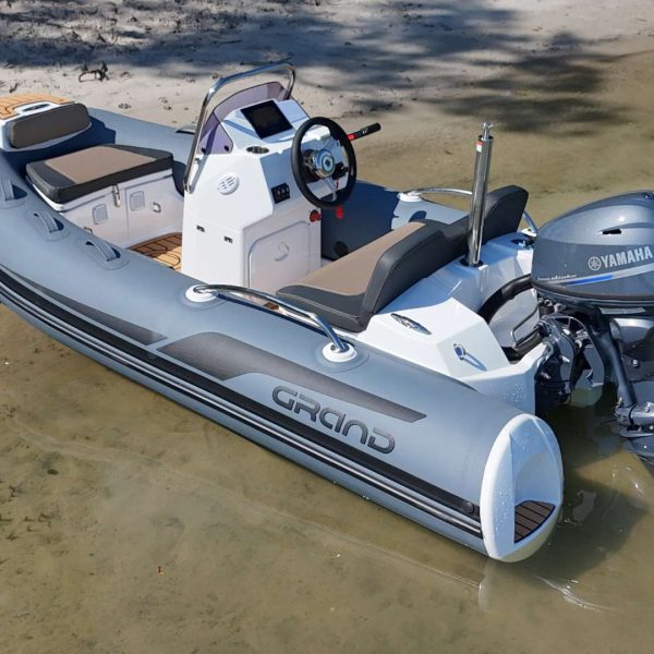 The Grand G340 tender boat beached on the sand in clear water