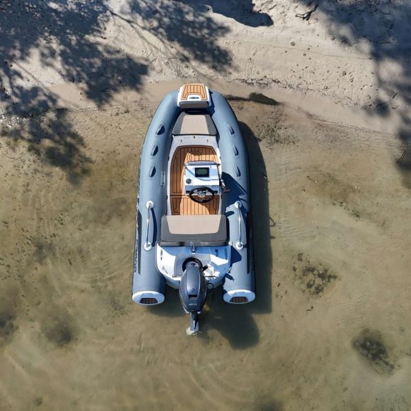 The Grand G340 tender boat beached on the sand in clear water