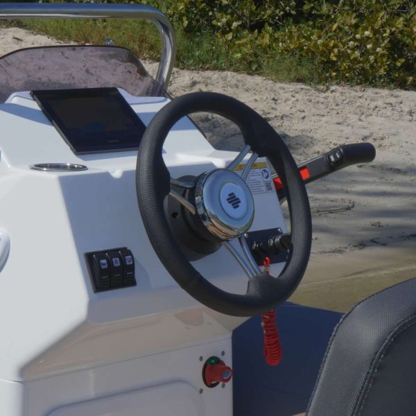 The Grand G340 tender boat steering console with steering wheel and Garmin Chart Plotter