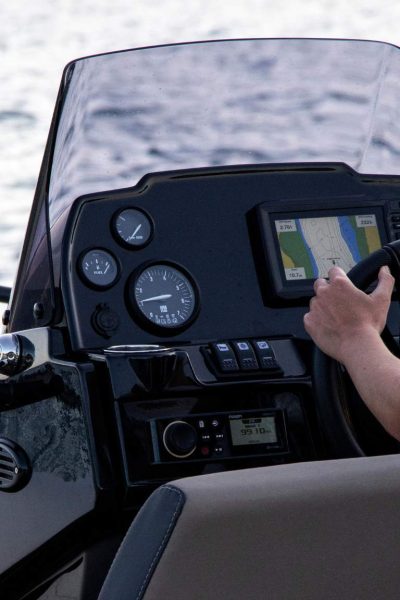 A woman driving a Grand G420 tender boat