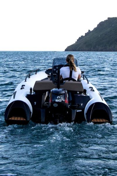 A woman driving the Grand G420 tender boat