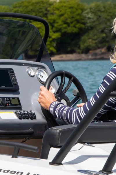 A woman driving the Grand G500 rigid inflatable boat