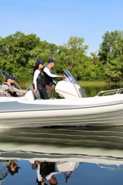 A white Grand G580 on the water with a group on board