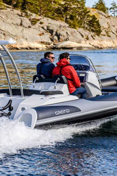 A Grand G580 on the water in Norway with two passengers on board