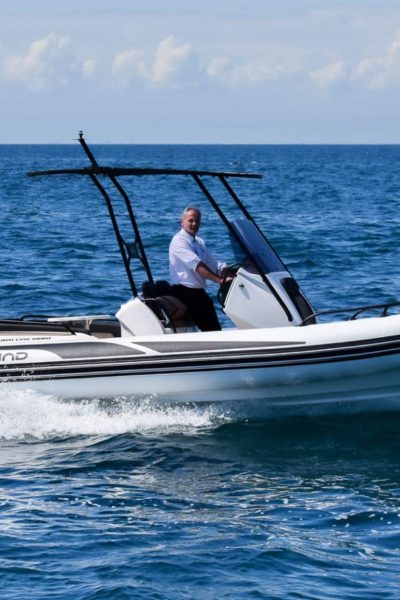 A Grand G680 rigid inflatable boat on the water with a driver on board