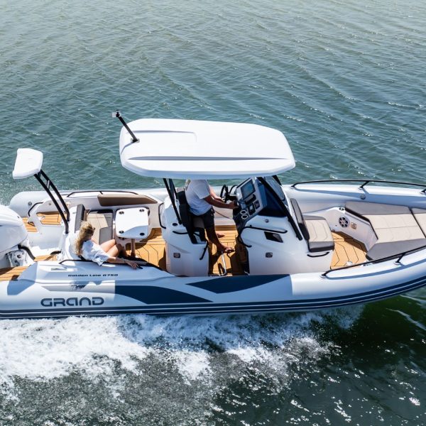 Two passengers on the Grand G750 centre console rigid inflatable boat travelling on the water